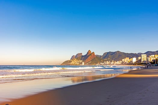 Sunrise on Ipanema beach in Rio de Janeiro with the sea and mountains