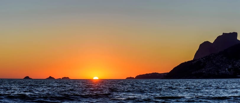 Sunset over the sea at Ipanema beach in Rio de Janeiro city during summer