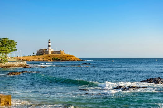 View of the famous Barra lighthouse in the all saints bay in the city of Salvador, Bahia