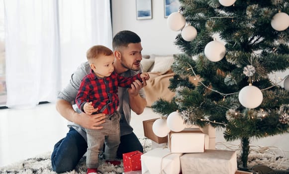 Father with his little son celebrates New year and christmas together.