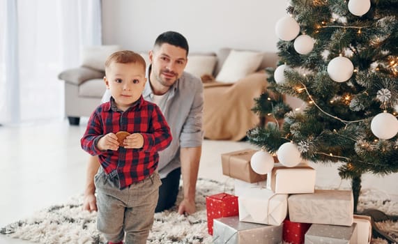 Father with his little son celebrates New year and christmas together.