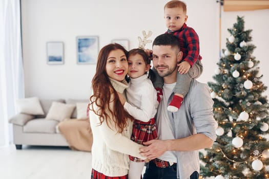 Beautiful family celebrates New year and christmas indoors at home.