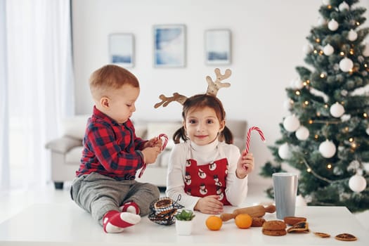Little brother with her daughter celebrates New year and christmas at home.