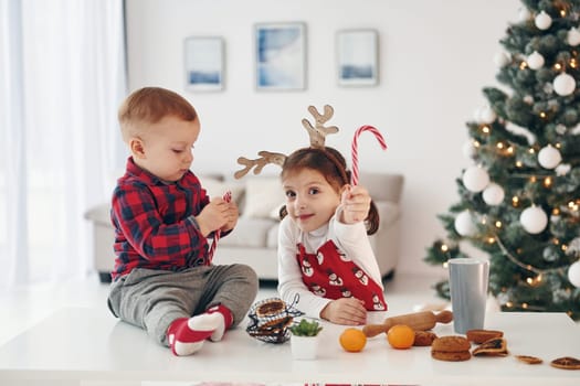 Little brother with her daughter celebrates New year and christmas at home.