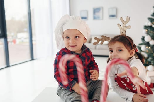 Little brother with her daughter celebrates New year and christmas at home.