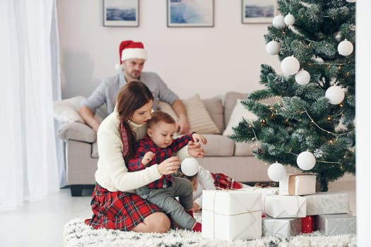 Beautiful family celebrates New year and christmas indoors at home.