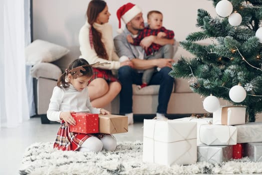 Beautiful family celebrates New year and christmas indoors at home.