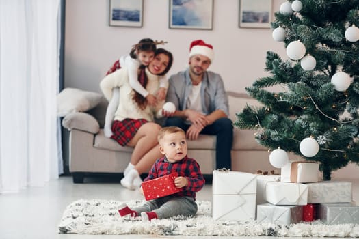 Beautiful family celebrates New year and christmas indoors at home.