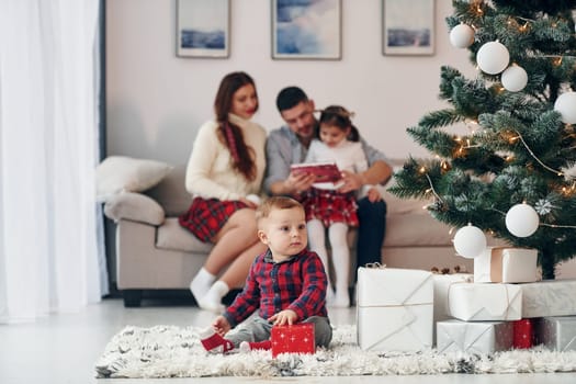 Beautiful family celebrates New year and christmas indoors at home.