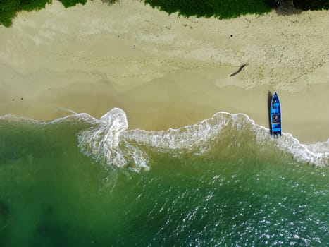 Aerial photo of a Traditional boat moored on the beach in Teluk Ijo, Banyuwangi. Indonesia.