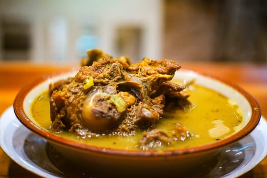 Tengkleng Kambing. Traditional Indonesian spicy soup made from the bones of goat served in a bowl.
