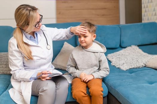 A family doctor examines a little boy at home. Pediatrician girl treats a child.