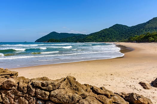 Beautiful tropical beach surrounded by rainforest on the coast of Sao Paulo state, Brazil