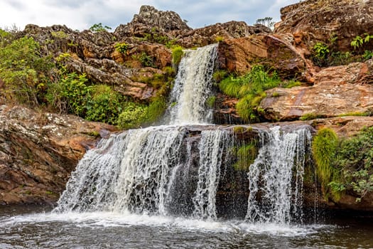 Waterfall between the rocks of Serra do Biribiri state park in Diamantina, Minas Gerais