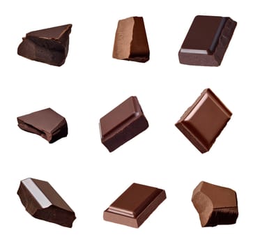 close up of chocolate pieces falling on white background
