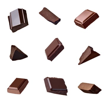 close up of chocolate pieces falling on white background