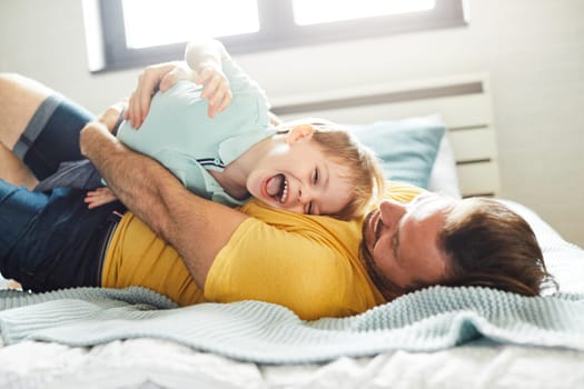 father and her son playing and having fun at home