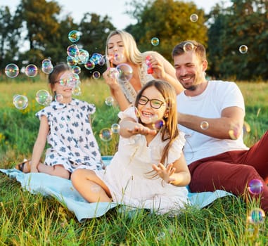 Portrait of a young happy family having fun outdoors