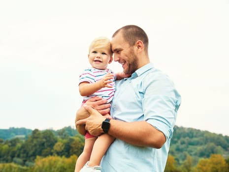 Portrait of a young happy family having fun outdoors