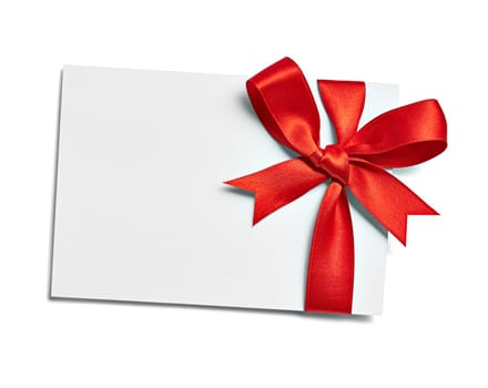 close up of a note card with red ribbon bow on white background