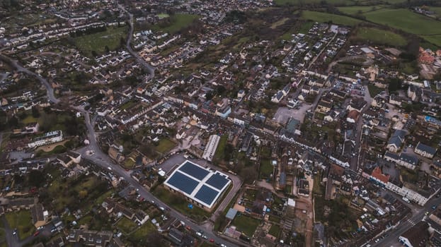 Aerial view of neighborhood surrounded by green landscape. High quality photo