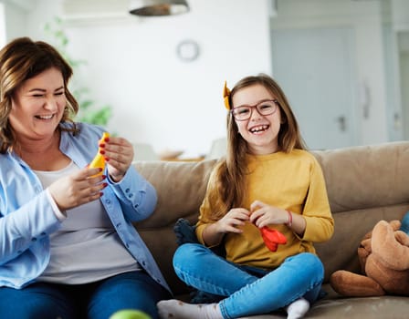 mother and daughter playing and having fun at home