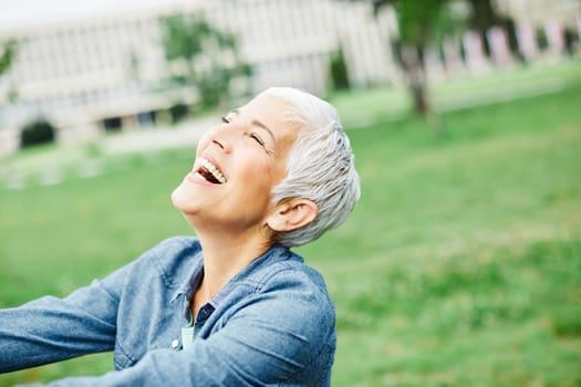 portrait of happy smiling senior woman outdoors