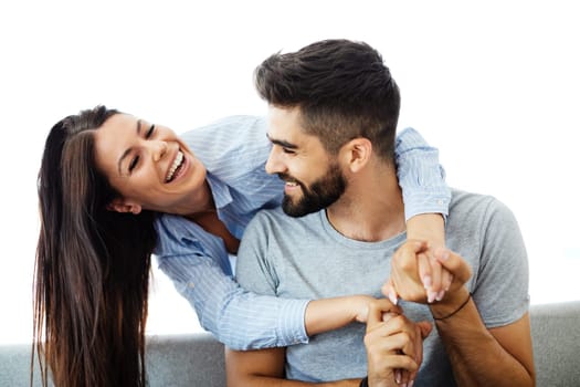 Portrait of a lovely young couple together on sofa at home