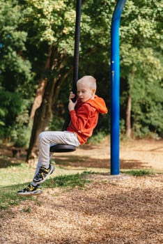 Funny cute happy baby playing on the playground. The emotion of happiness, fun, joy. Smile of a child. boy playing on the playground.