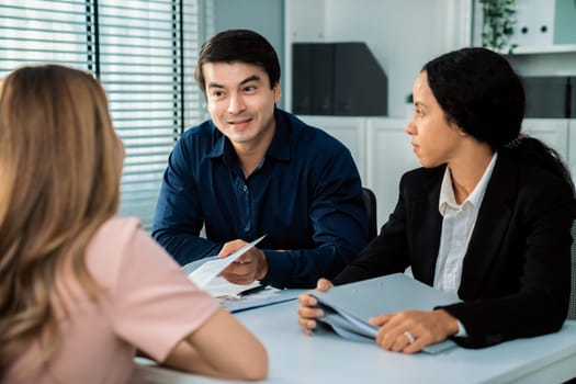 A young female asian candidate tries to impress her interviewer by being competent. International company, multicultural environment in workplace.