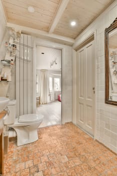 a bathroom with white walls and wood ceiling above the toilet in an orange tiled floor is visible on the wall