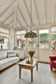 a living room with two couches and a coffee table in front of the window that looks out onto the street