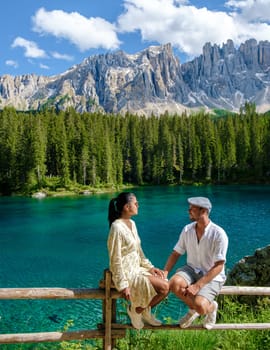 bleu lake in the dolomites Italy, Carezza lake Lago di Carezza, Karersee with Mount Latemar, Bolzano South Tyrol, Italy. The landscape of Lake Carezza or Karersee and the Dolomites in the background