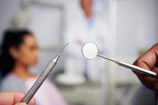 The countdown to zero cavities. an unrecognisable dentist holding dental tools in an office