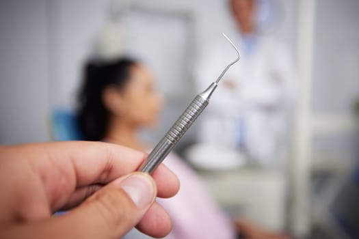 The moment of tooth. an unrecognisable dentist holding dental tools in an office