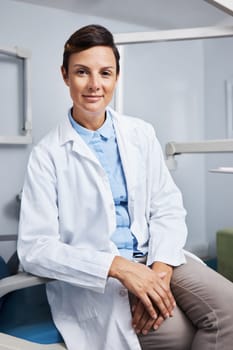 What can I do for your teeth. Portrait of a confident young woman working in a dentists office