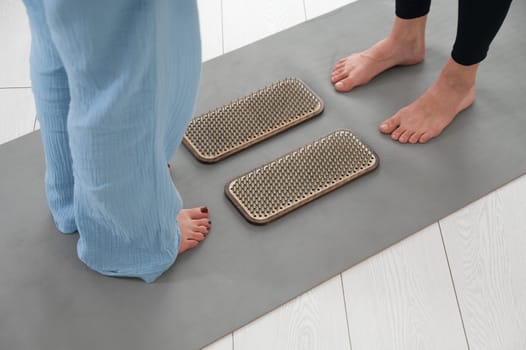 Female feet next to sadhu boards in yoga studio