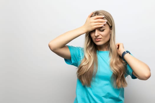 girl holding on to a sore head on a white background.