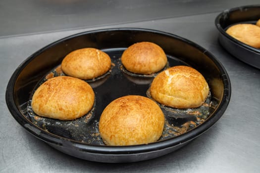 Freshly baked hot burger buns in an industrial oven