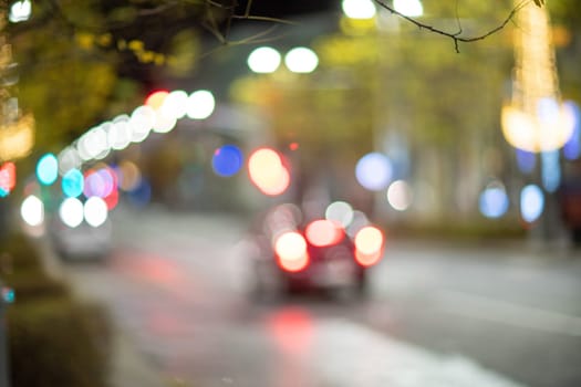 Blurred footage of transport. Blur of city lights along the road, light out of focus at night. Night city traffic, beautiful background