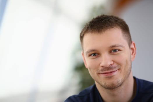 Portrait of handsome smiling young man with stubble. Positive emotions concept