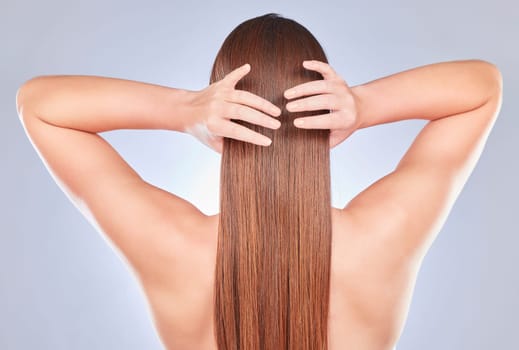 Hair touch, woman and back of a model with beauty, wellness and soft hairstyle texture in a studio. Cosmetics, shampoo treatment and keratin of a female with healthy, clean and haircare aesthetic.