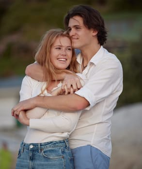 Couple hug on beach, travel and content with love and commitment in relationship, adventure and romance. Trust, partnership and care with young people outdoor, tropical holiday and happiness on date.