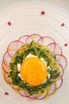 Recipe of courgette meat, onion, potato, garlic, pepper, coriander and egg yolk fried on a bed of round radish, High quality photo
