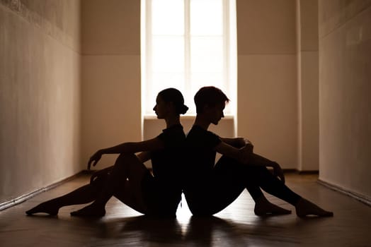 Silhouette of two beautiful young dancers