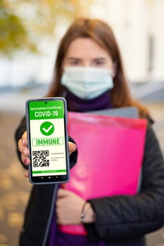 Student girl showing electronic coronavirus certificate