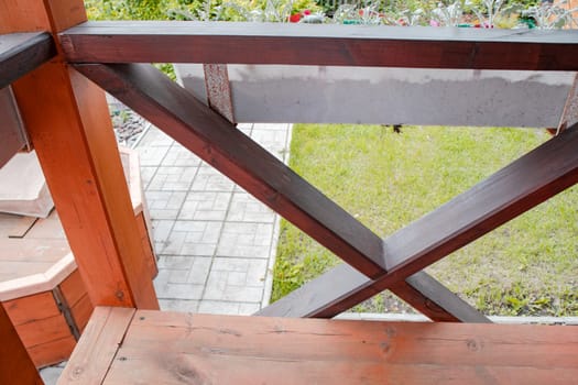 Close-up of the fence on the porch of the terrace, view from the inside. blurred summer garden background.