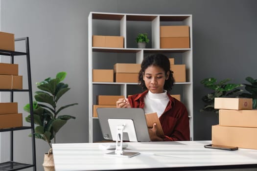 Beautiful African Americans woman live streaming at her shop. Business online influencer on social media concept. Online Selling. Online Shopping.