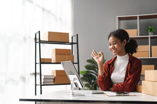 Beautiful African Americans woman live streaming at her shop. Business online influencer on social media concept. Online Selling. Online Shopping.