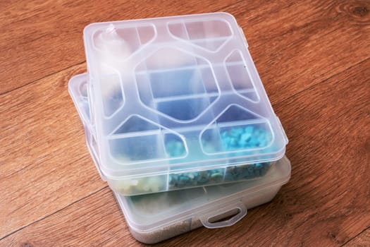 Small storage containers on a wooden floor close up